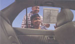 Image of a father and son looking at a car for sale