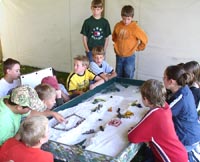 students at the 14th annual Environmental Fair at the Lyon County Fairgrounds in Marshall, Minnesota, participate in a table interactive display to learn more about soils and the environment in which they live and go to school