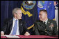 President George W. Bush talks with U.S. Army Sgt. First Class Kenneth Williams, as he meets with military personnel Wednesday, June 28, 2006, at the VFW Overland-St. Ann Memorial Post #3944 in St. Louis, Mo., who recently have returned from Iraq and Afghanistan. White House photo by Kimberlee Hewitt