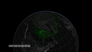 We move in close to the polar regions and see the faint glow of the aurora in green.
