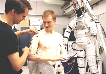MyoMonitor  being attached to a male's arm in order to study the muscles of astronauts in the weightless environment of space