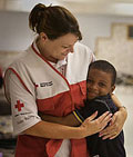 Port Allen, Louisiana. Red Cross volunteer Martha Teaster receives a big hug from Jason Wase in Erwinville Community Center shelter. Talia Frenkel/American Red Cross.