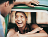 Woman sitting in car smiling