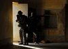 An Iraqi special weapons and tactics team, alongside U.S. Special Forces soldiers, conduct an operation in a village in Diyala province, Iraq, to disrupt an al-Qaeda network, Sept. 5, 2008.