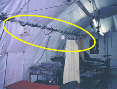 Photo of a medical facility using the PODS System.  A yellow circle highlights the tubes used in oyxgen distribution suspended above the work/patient area.