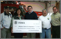 Dennis Varner, Dillingham Mayor Alice Ruby, along with Robert Powers, FEMA's Deputy Assistant Administrator for Disaster Operations, Dillingham Fire Chief Norman Heyano and FEMA's Alaska area manager Robert Forgit at the check presentation. FEMA Photograph by Mike Howard