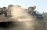 Roofers cutting tile