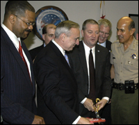The new Joint Regional Intelligence Center opened July 27. Officials in the foreground, left to right, are Willie Hulon, head of the FBI's National Security Branch, LAPD Chief William Bratton, J. Stephen Tidwell, head of the FBI's L.A. field office, and Los Angeles County Sheriff Leroy Baca.
