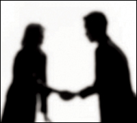 Silhouettes shaking hands