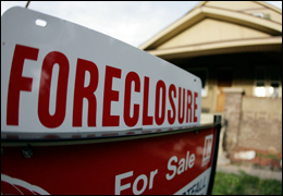 Picture of a home with a foreclosure sign in front. AP Photo.