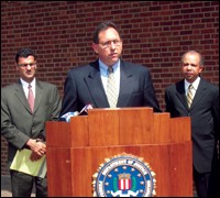 Philadelphia FBI Assistant Special Agent in Charge Brian Lynch is joined by Salam Al-Marayati, Executive Director MPAC, left, and Assistant U.S. Attorney Jeff Whitt during a May press conference in Philadelphia