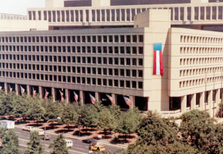 Photograph of JEH Building with historic flags and banner