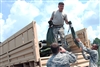 As Hurricane Gustav inches closer towards the gulf, U.S. Army Pfc. Seth D. Watkins, Spc. Donovan Q. Lemieux, and Sgt. 1st Class Todd F. Stremlau, members of 204th Theater Airfield Operations Group, load up a Light Medium Tactical Vehicle with a set of tents in support of hurricane operations for Hurricane Gustav in New Orleans.