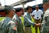 Louisiana Gov. Bobby Jindal, center, shakes hands with U.S. Army Col. Jonathan Ball, commander of the Louisiana National Guard's 256th Brigade Combat team, in New Orleans, Aug. 30, 2008. Jindal and Army Maj. Gen. Bennett C. Landreneau, Louisiana National Guard adjutant general, second from left, met Ball at the bus terminal in New Orleans where residents are preparing to evacuate the city prior to the arrival of Hurricane Gustav.