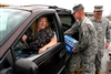 An evacuee from Hurricane Gustav smiles as Army Pfc. Alex Armstrong, Mississippi Army National Guard, places bottled water into her car, Sept. 2, 2008, at a distribution point just outside Gulfport, Miss. Citizens who evacuated to safer areas as the hurricane approached began returning to the area after the storm passed.