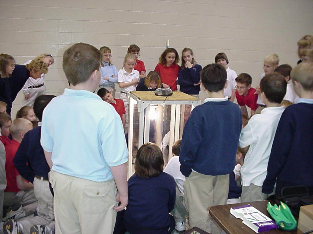 Grade-school students look on as the "tornado-in-a-box" is demonstrated