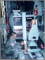 The dropsonde system operator prepares to drop the parachute-borne sensor.