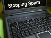Graphic of laptop with the words "Stopping Spam"
