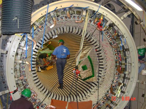 The rotor for unit 1 is lifted by cable, prior to being transported for re-wiring