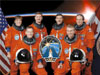 The STS-115 crew posing in their orange launch and entry suits