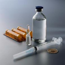 Photograph of a medicine bottle and a syringe