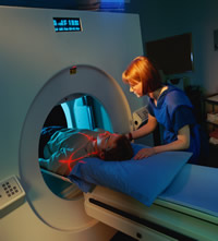 (photo of patient in a CT machine)