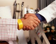 Photograph of a handshake between a male patient and a male doctor
