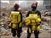 Photo of two rescue workers looking at the World Trade Center site.