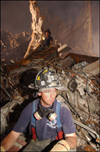 Photo of New York fire worker taking a break amongst the debris of the World Trade Center.