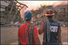 Photo of two iron workers looking at the World Trade Center debris.