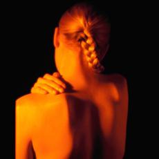 Photograph of a woman holding her shoulder in pain