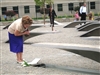 A visitor to the Pentagon Memorial scans items left by vistors under one of the park's 184 inscribed memorial units, which honor the Sept. 11, 2001, terrorist attack victims that died at military headquarters. The memorial park was dedicated on Sept. 11, 2008. 