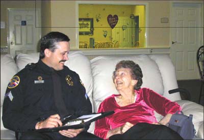 Photograph of police officer taling to an elderly woman in her home