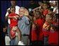 President George W. Bush joins children from Lakewest Family YMCA on stage after speaking on his Health and Fitness Initiative in Dallas, Texas, Friday, July 18, 2003.  White House photo by Eric Draper