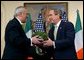 Irish Prime Minister Bertie Ahern presents a shamrock plant to President George W. Bush during an annual shamrock ceremony in the Roosevelt Room Thursday, March 13, 2003.  White House photo by Tina Hager