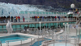 visitors looking at glacier from cruise ship deck