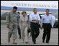 President George W. Bush and Laura Bush walk with Lt. General Russel Honore, left, and Plaquemines Parish president Benny Rousselle, right, upon their arrival Monday, Oct. 10, 2005 at the U.S. Naval Air Station, Joint Reserve Base in New Orleans, La.  White House photo by Eric Draper