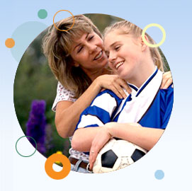 Image of woman and girl holding a soccer ball