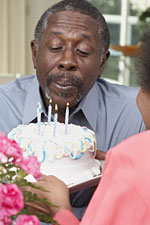 Image of a man blows candles