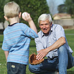 Image of an old man with his grandson throwing ball