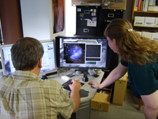 Zolt Levay (left), and Vanessa Thomas, review data retrieved from the Hubble Space Telescope archive