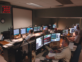 people sitting in front of computers in the Space Telescope Operations Control Center