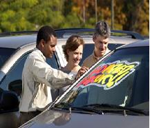 Picture of three people talking about a car