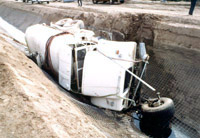 Large truck on its side in a trench