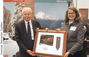 Retired FLHP Administrator Thomas Edick is shown here receiving a Byways Pioneer Award from Teresa Mitchell, executive director of Seaway Trail, Inc. The Seaway Trail is a National Scenic Byway.