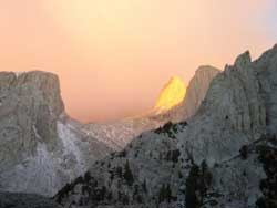 [Photo]: Glow of the sun on peak face in winter