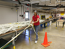 Worker measures parachute straps