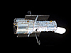 The Hubble Space Telescope floats against the blackness of space