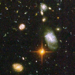 An irregular galaxy, Sextans A does not have a simple shape like a spiral or elliptical galaxy. The bright, yellowish stars in the foreground are part of the Milky Way, Earth's "home" galaxy.