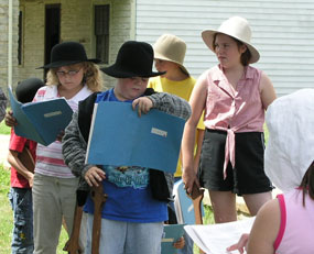 Kids performing in a play during a special event.